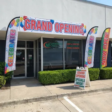 Grand opening banners and flags outside a storefront