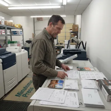 Print shop team preparing direct mail campaign materials