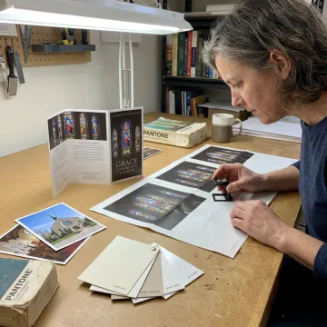 Designer reviewing church brochure layout