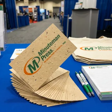 Trade show booth displaying plantable seed paper business cards as giveaways