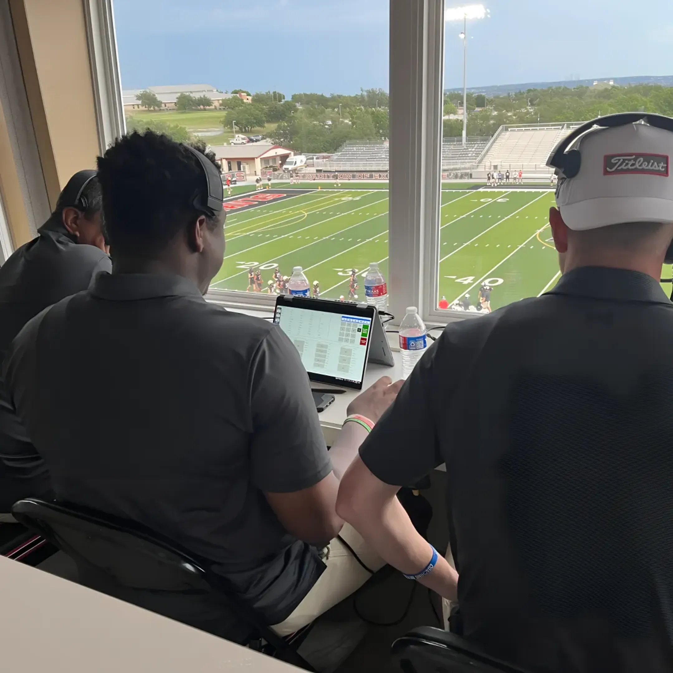 Coaches charting quarterback grading data on tablets