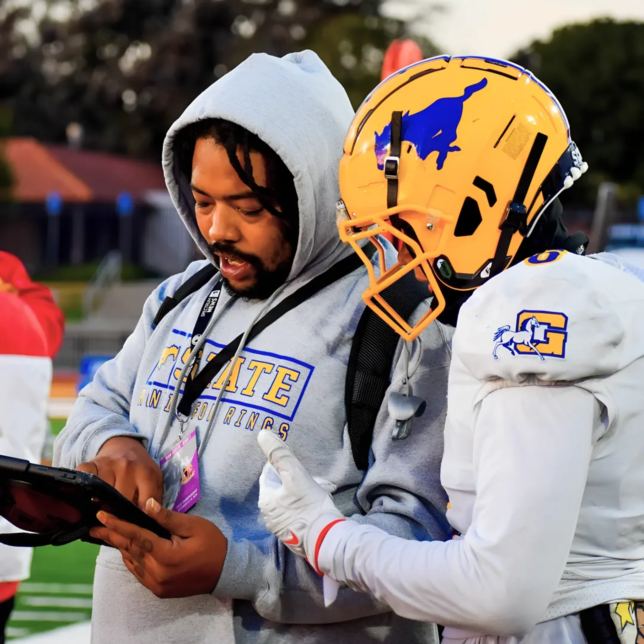 Football coach using tablet for automated MaxPreps stats