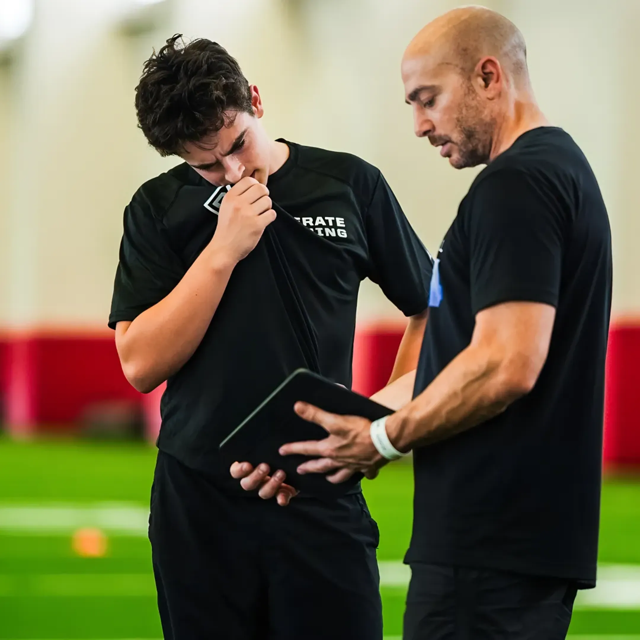 Football coaches reviewing real-time analytics dashboard