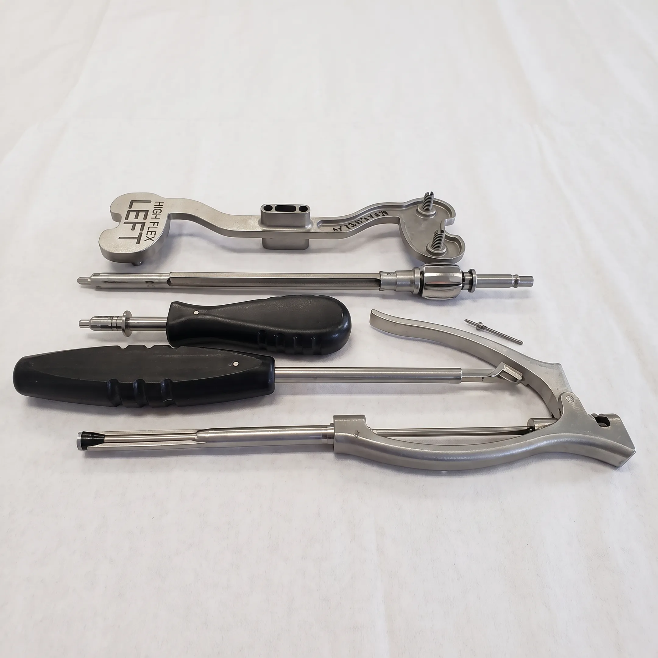 Precision machined orthopedic component beside inspection tools and manufacturing equipment