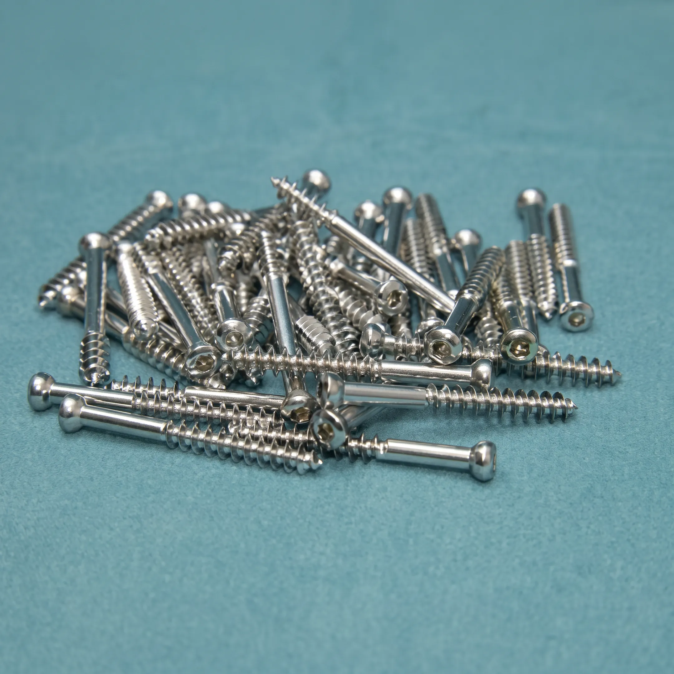Engineer reviewing an intramedullary hip screw design with precision-machined orthopedic components