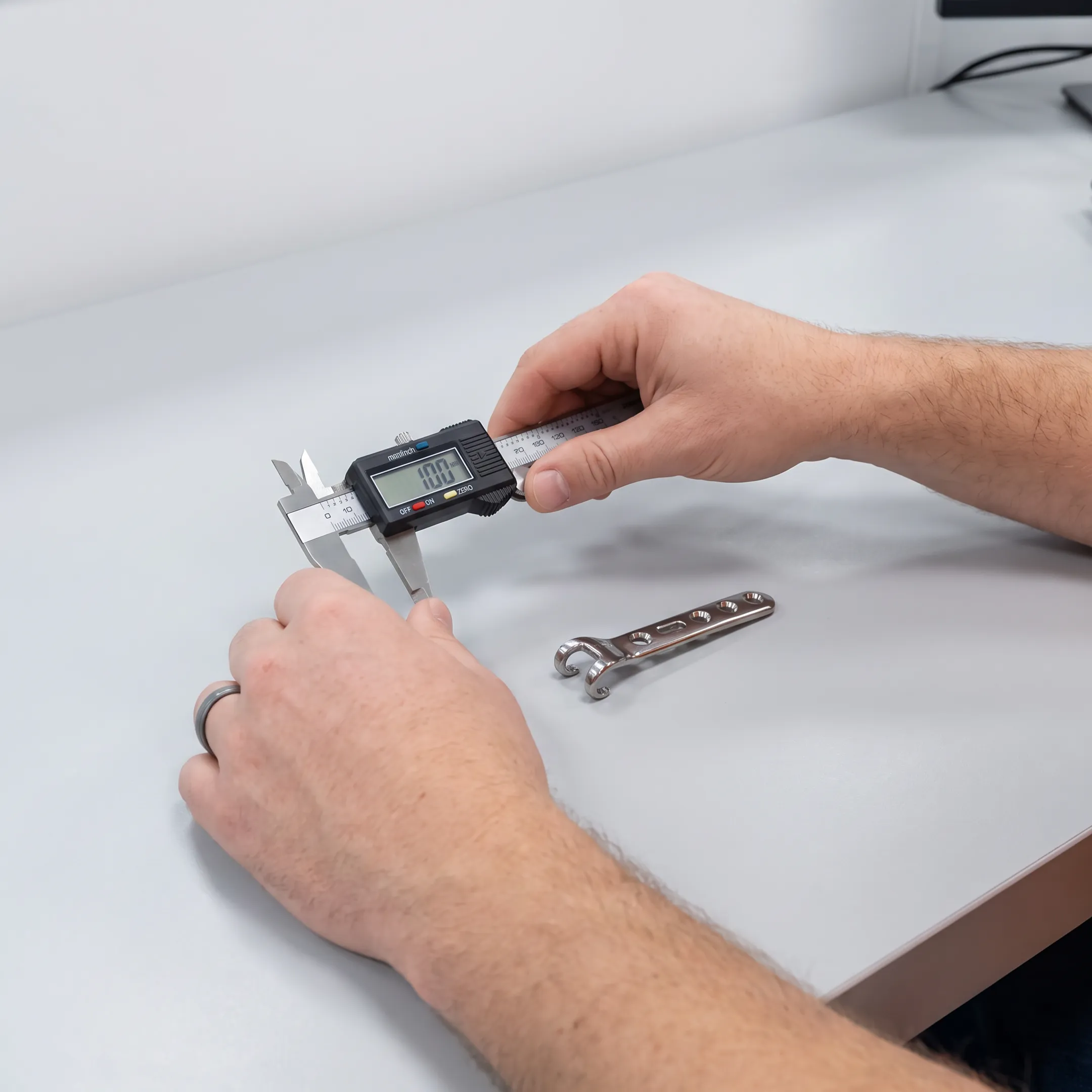 Orthopedic hook plate prototype undergoing precision inspection