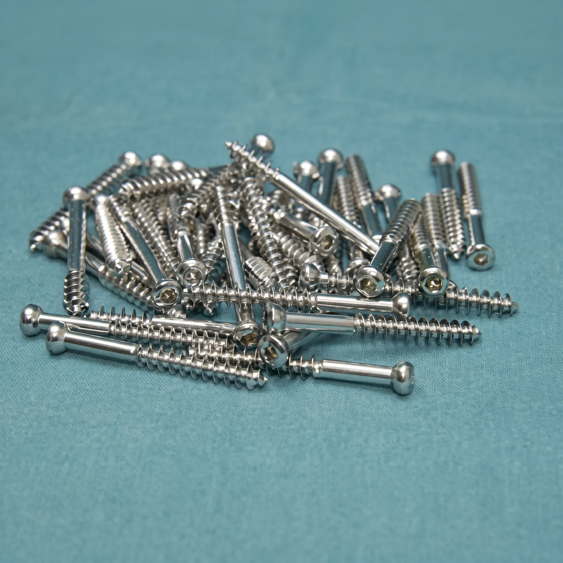 Precision-machined headless compression screws beside orthopedic medical device components