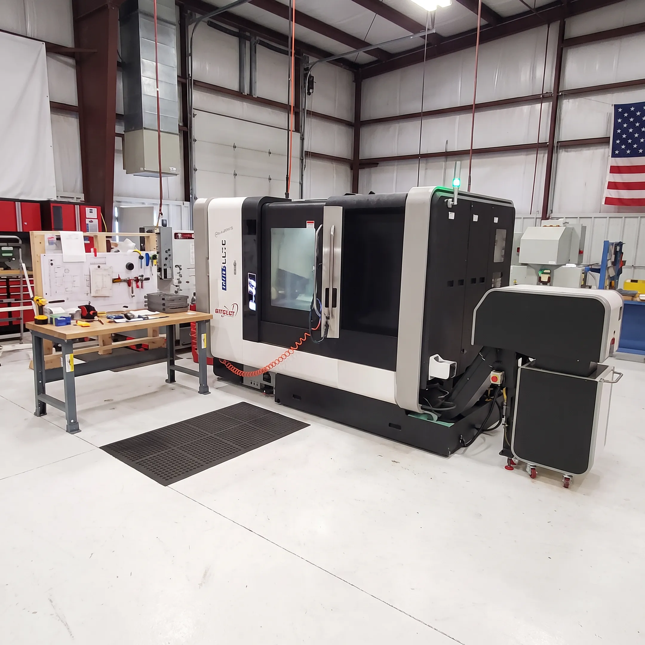 Engineer reviewing a precision orthopedic instrument beside CNC machining equipment