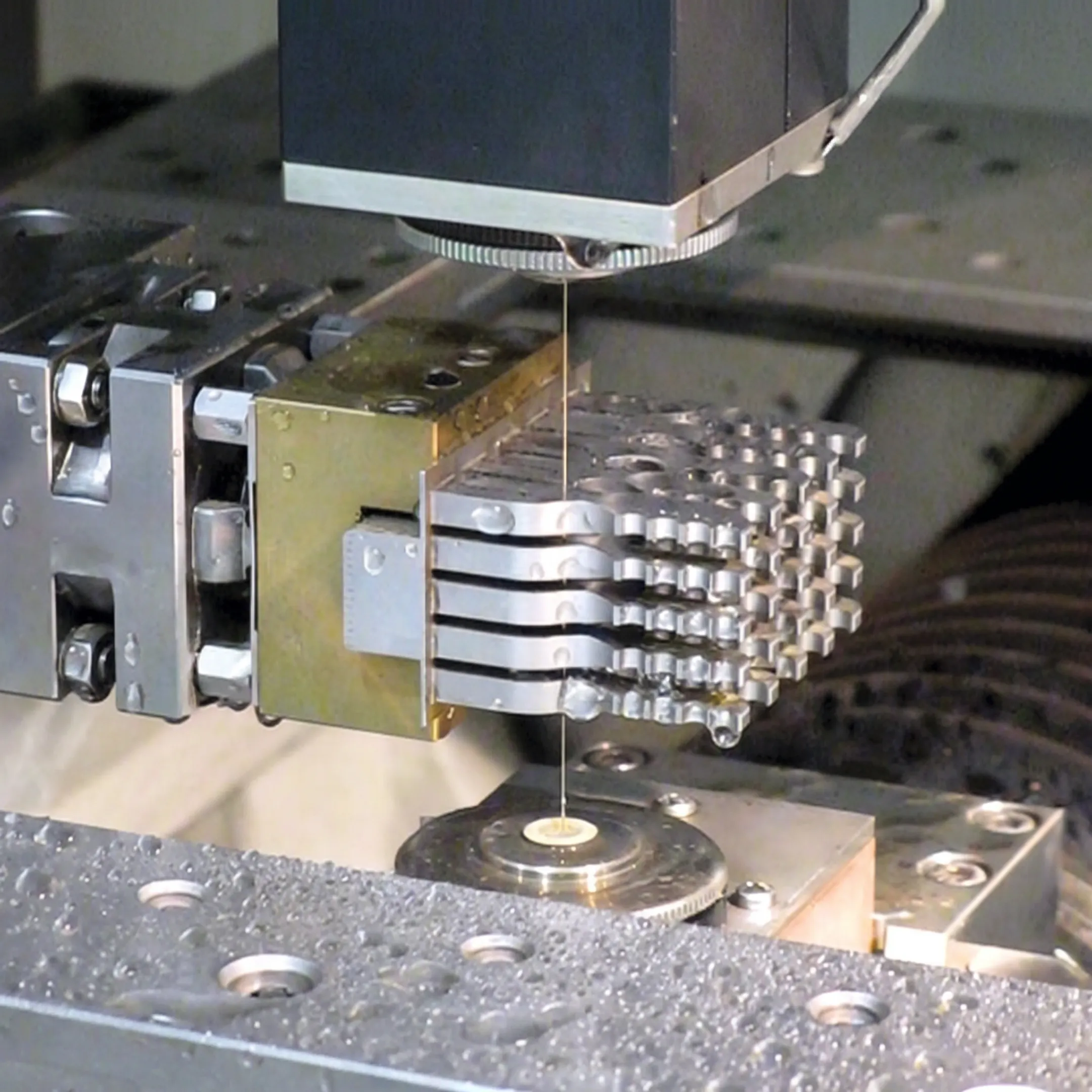 Technician inspecting a wire EDM machined orthopedic component