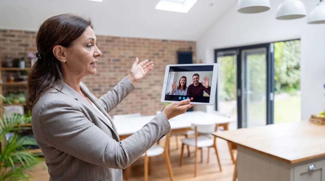 Real estate agent conducting virtual home showing via video call for remote sellers