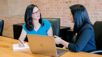 Manager conducting one-on-one career development conversation with employee in office setting