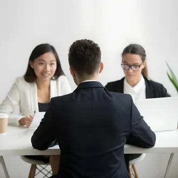 Business owner and HR consultant discussing compliance