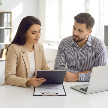 HR consultant reviewing compliance documents with a business leader