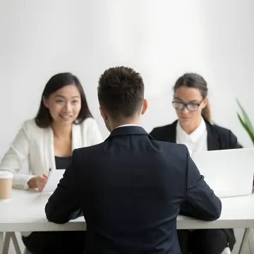 Manager and HR consultant discussing employee communication strategy