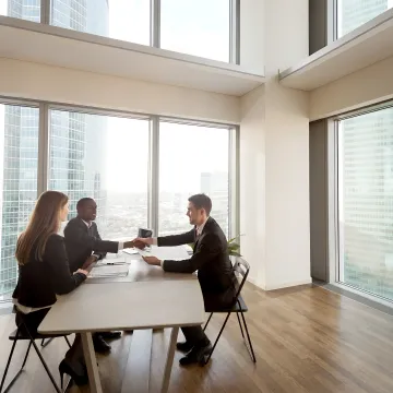 Consultant discussing handbook policies with business leader