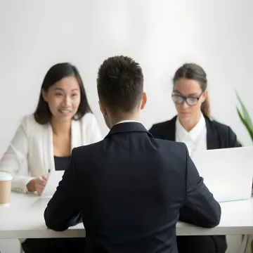 Manager coaching employee during a workplace meeting