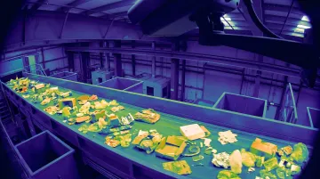 Fixed thermal imaging camera mounted over industrial conveyor line detecting heat anomalies in waste facility