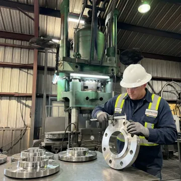 Stainless steel pipe angle ring flanges undergoing quality inspection at MTS Forge