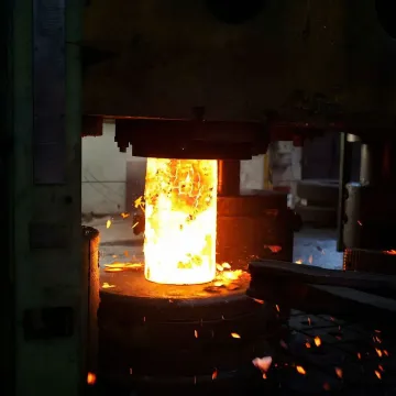 Carbon steel valve forging process inside an industrial forge press facility