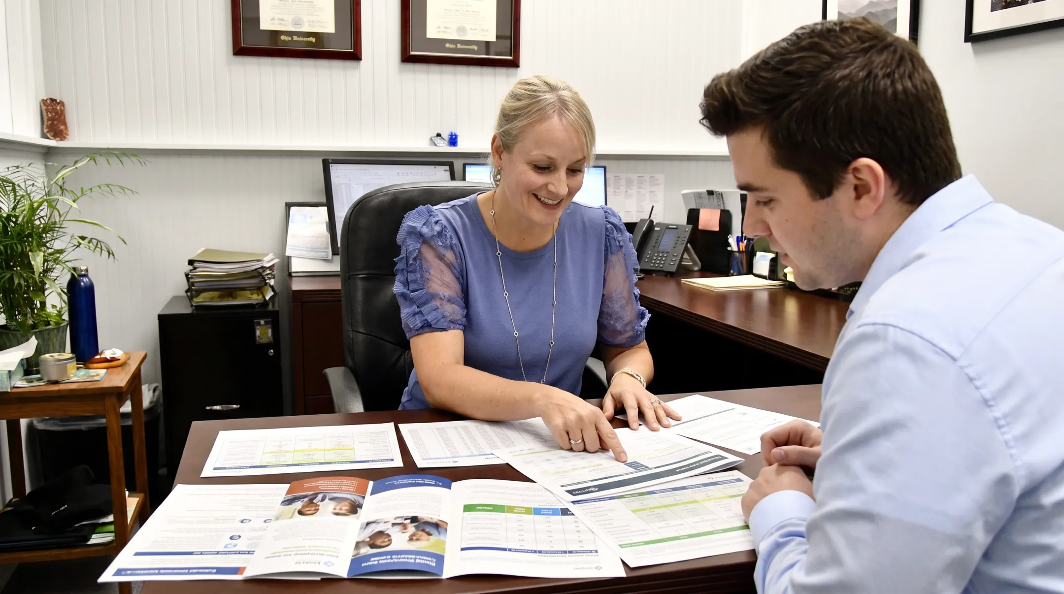Benefits advisor consulting small business owner on health plan options