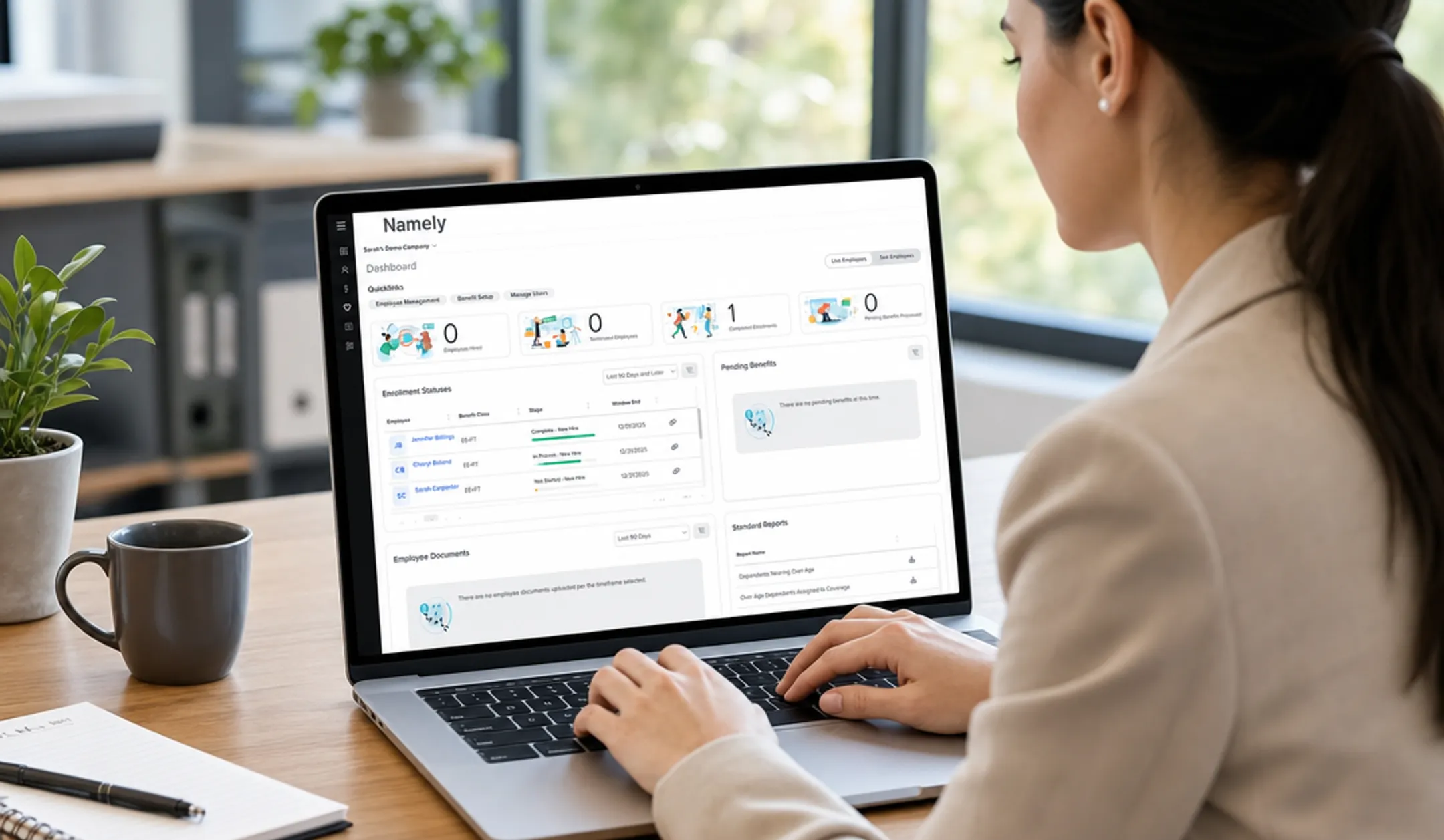 HR professional using benefits administration software on laptop dashboard