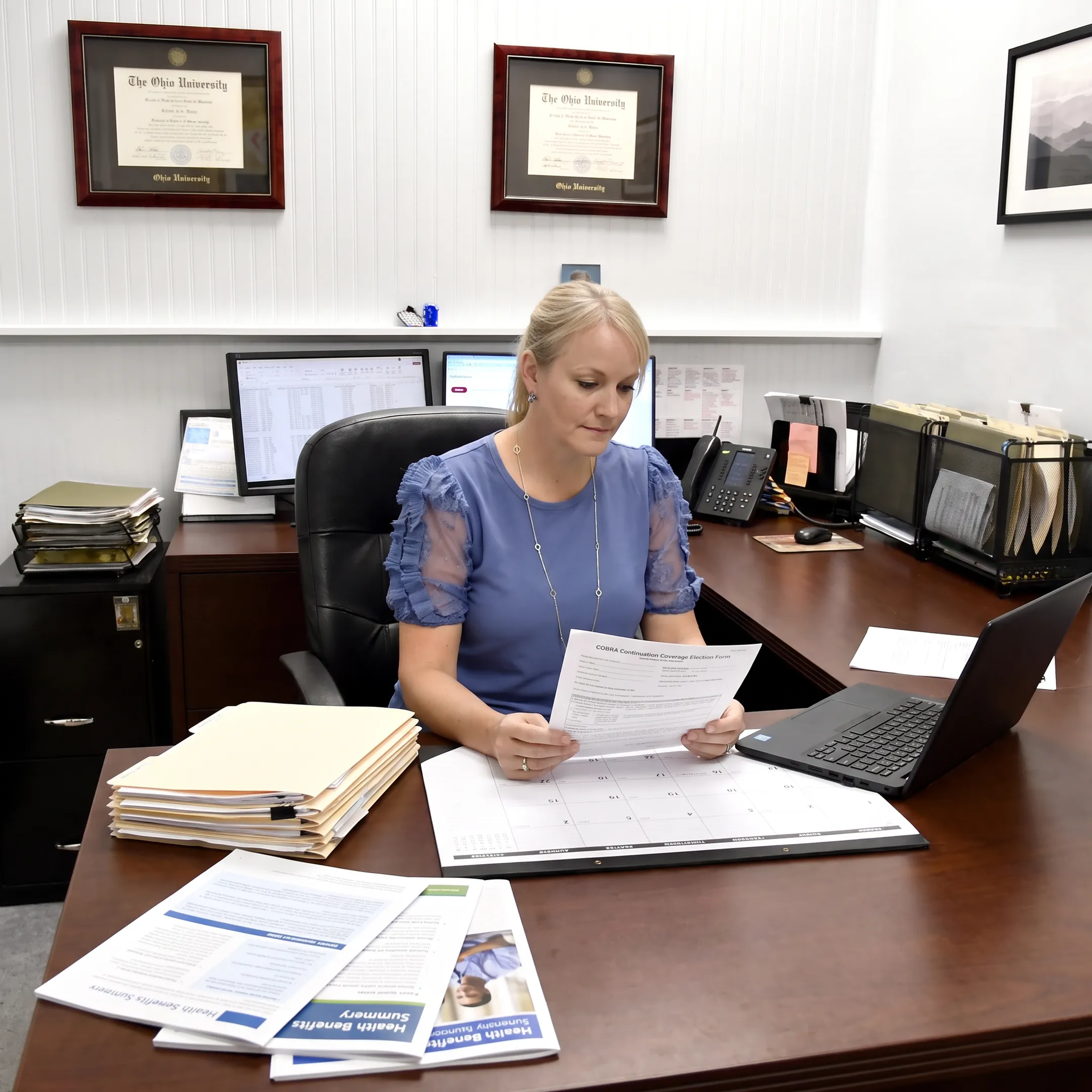 HR professional reviewing COBRA benefits paperwork