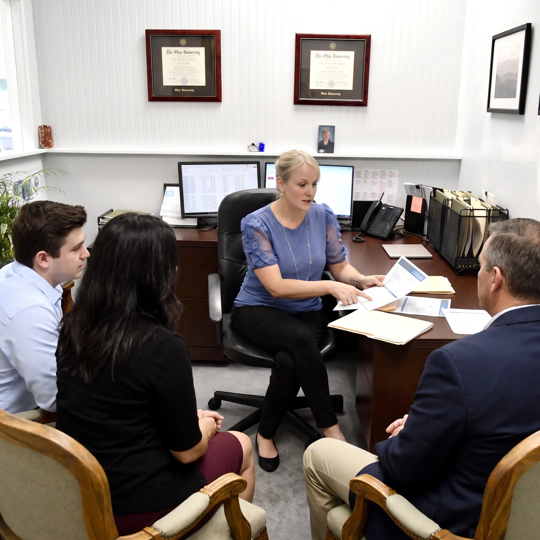 Insurance adviser reviewing coverage options with clients