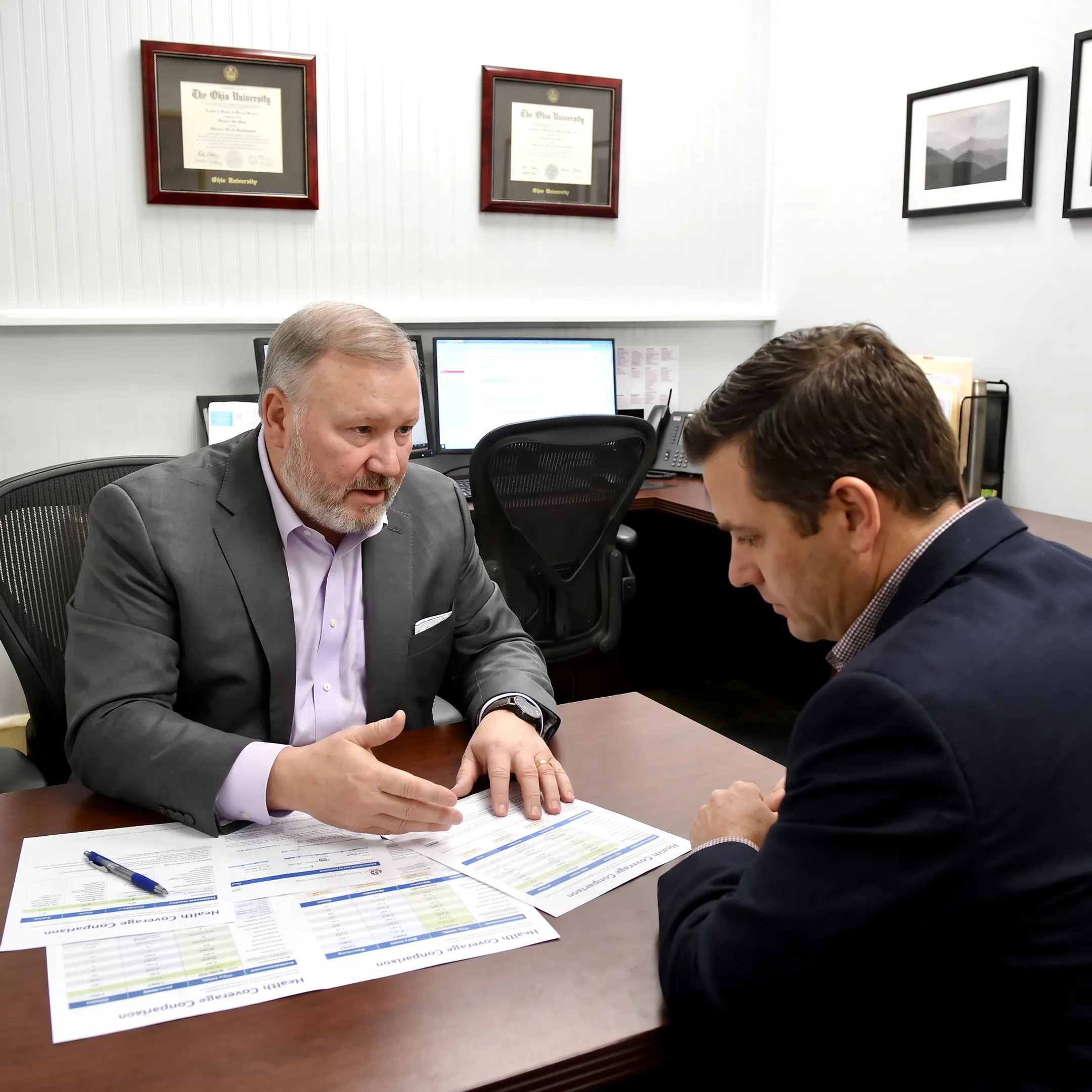 Benefits adviser explaining health coverage options