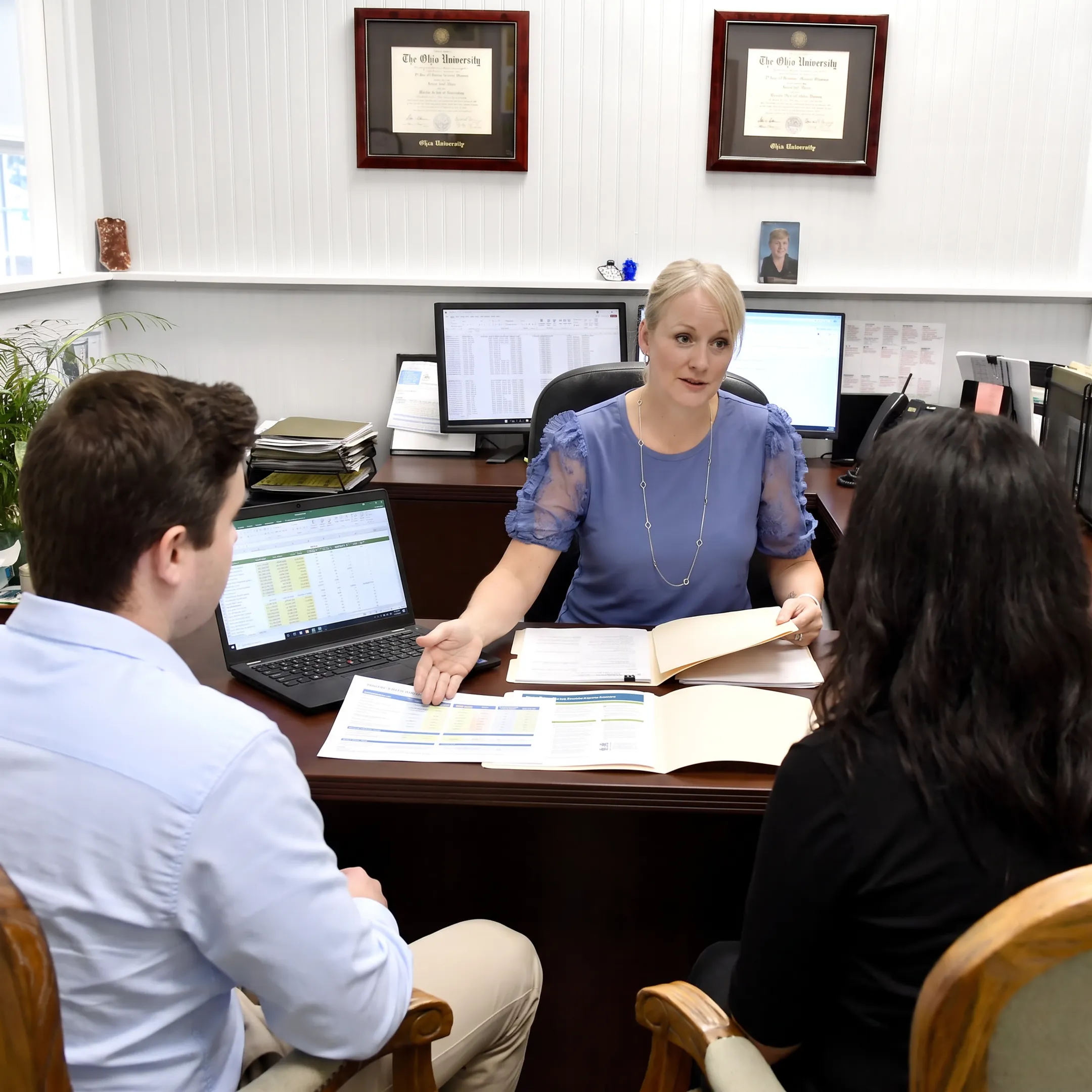 Insurance adviser explaining health plan options to clients