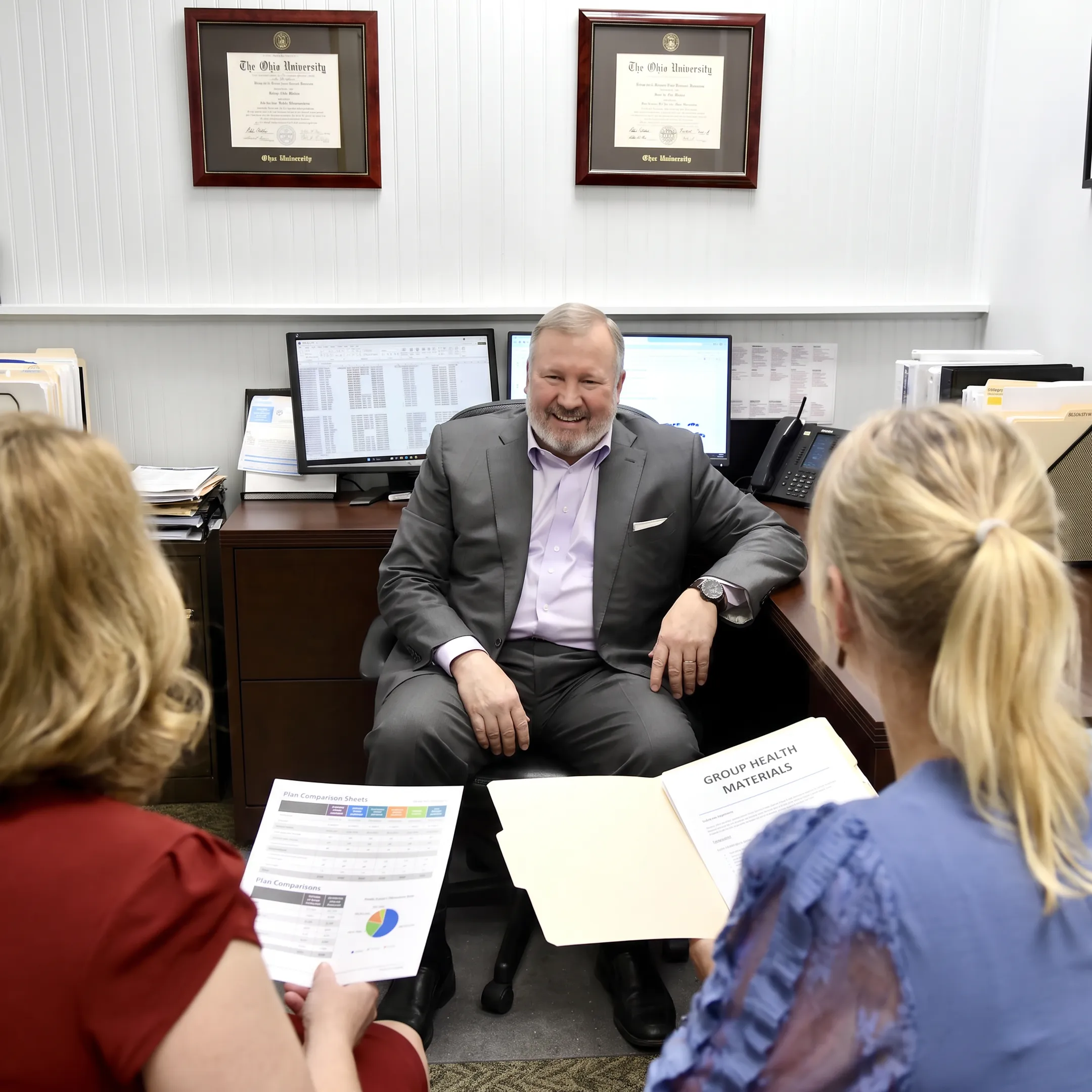 Advisor explaining health benefits to employer