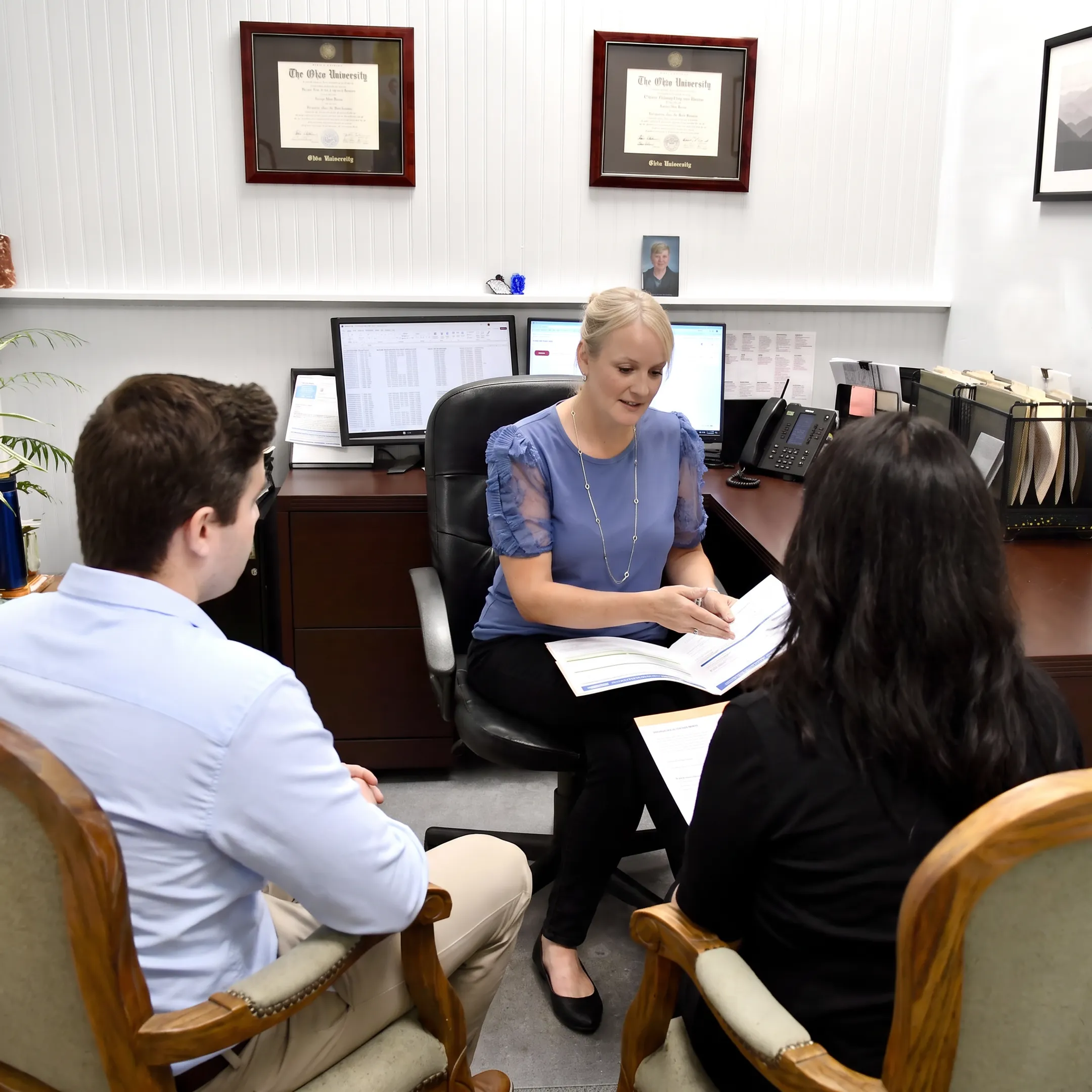 Agent explaining health insurance plans to a client