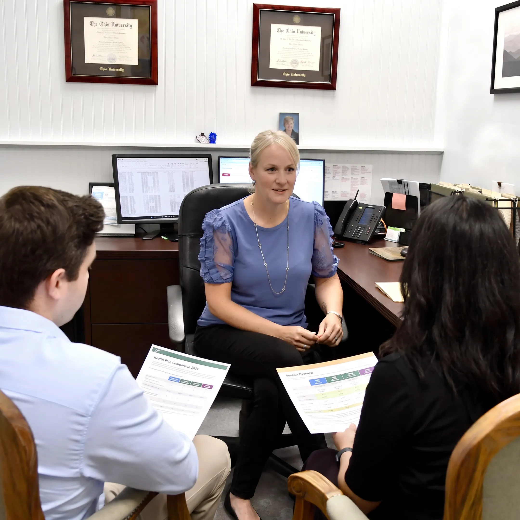 Agent explaining insurance plans to a client