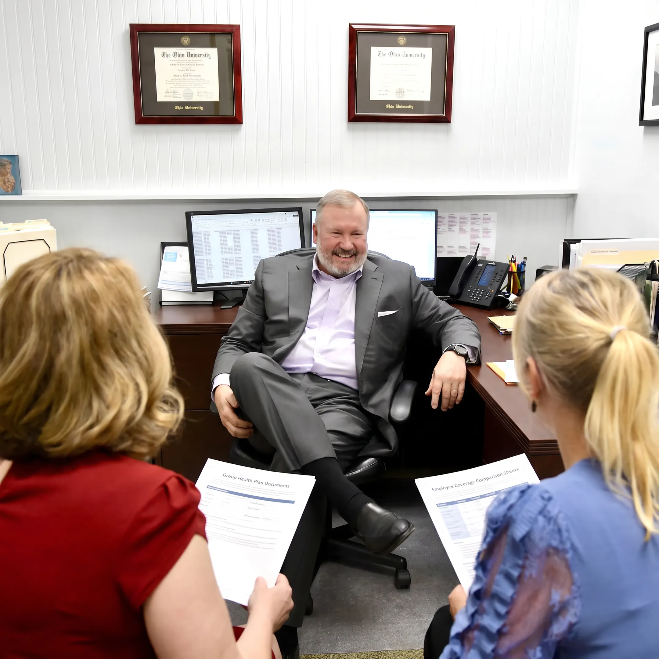 Benefits adviser discussing health plan choices with employer