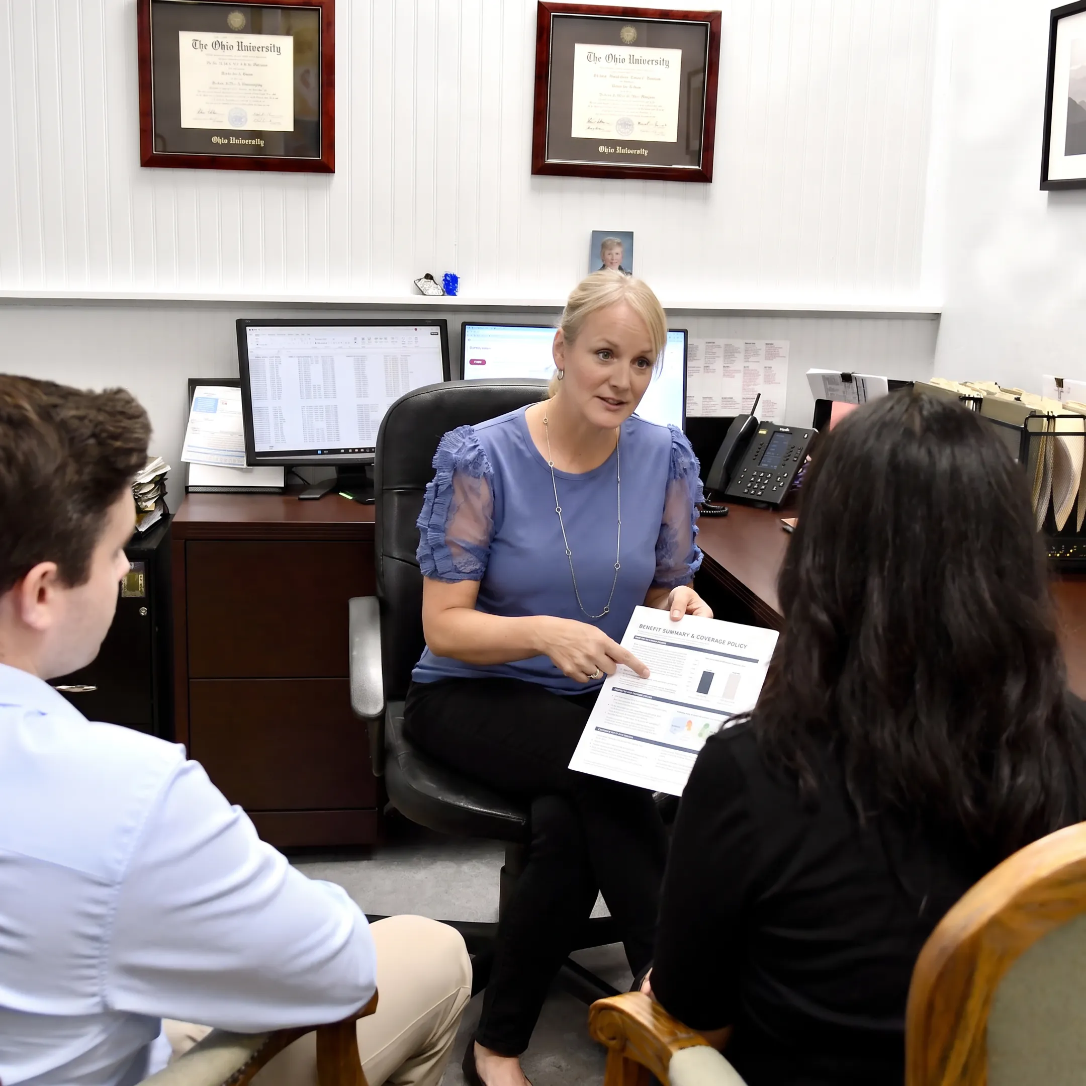 Advisor explaining health insurance benefits to a client