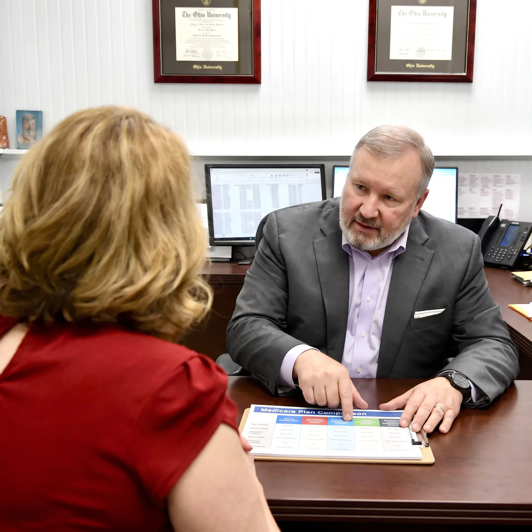 Advisor helping a client compare Medicare coverage