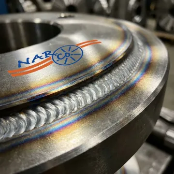 Close-up of precision steel welding work on industrial cable reel flange