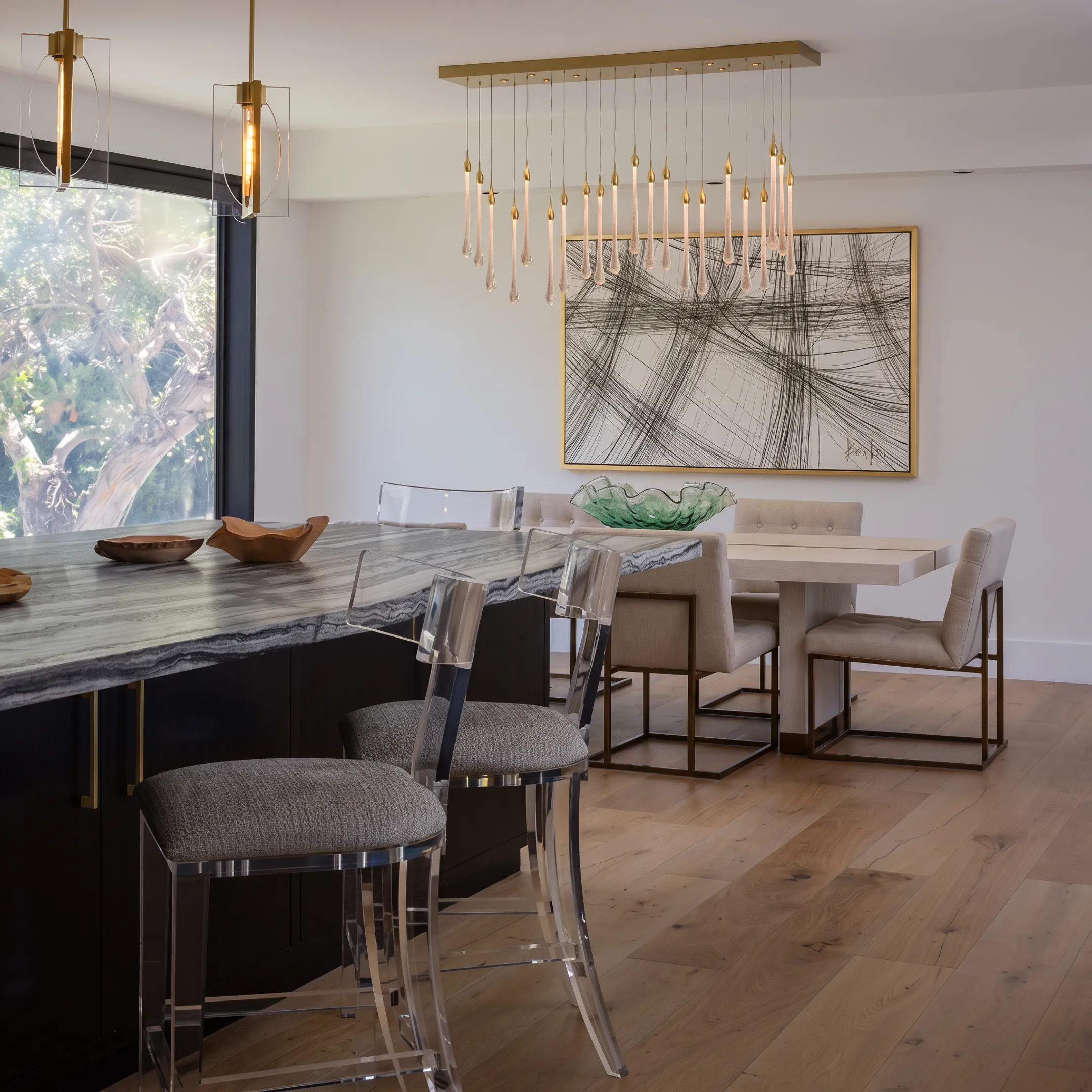 Contemporary designer dining area showcasing custom woodwork and artistic lighting.