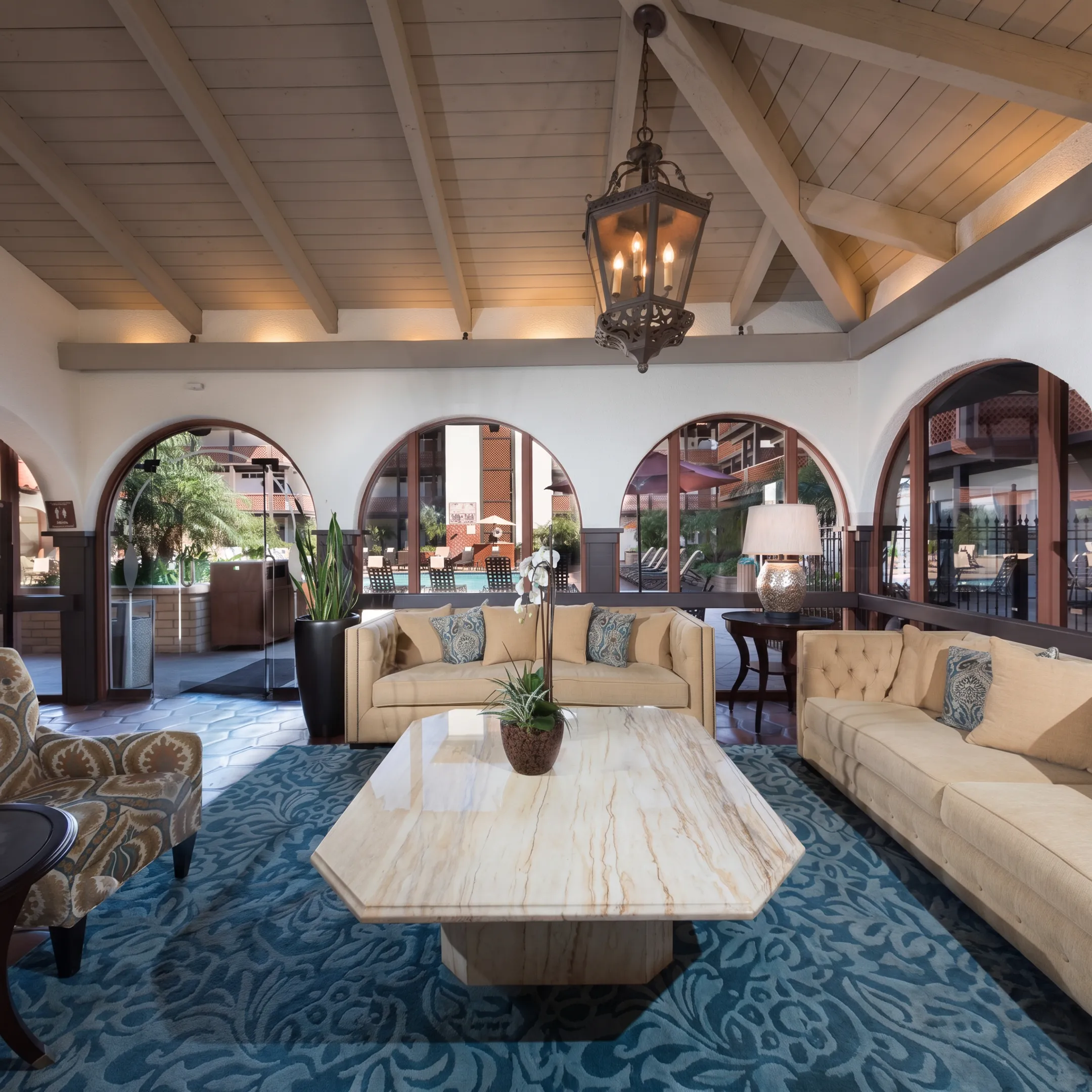 Designers reviewing custom furniture fabric swatches and architectural blueprints