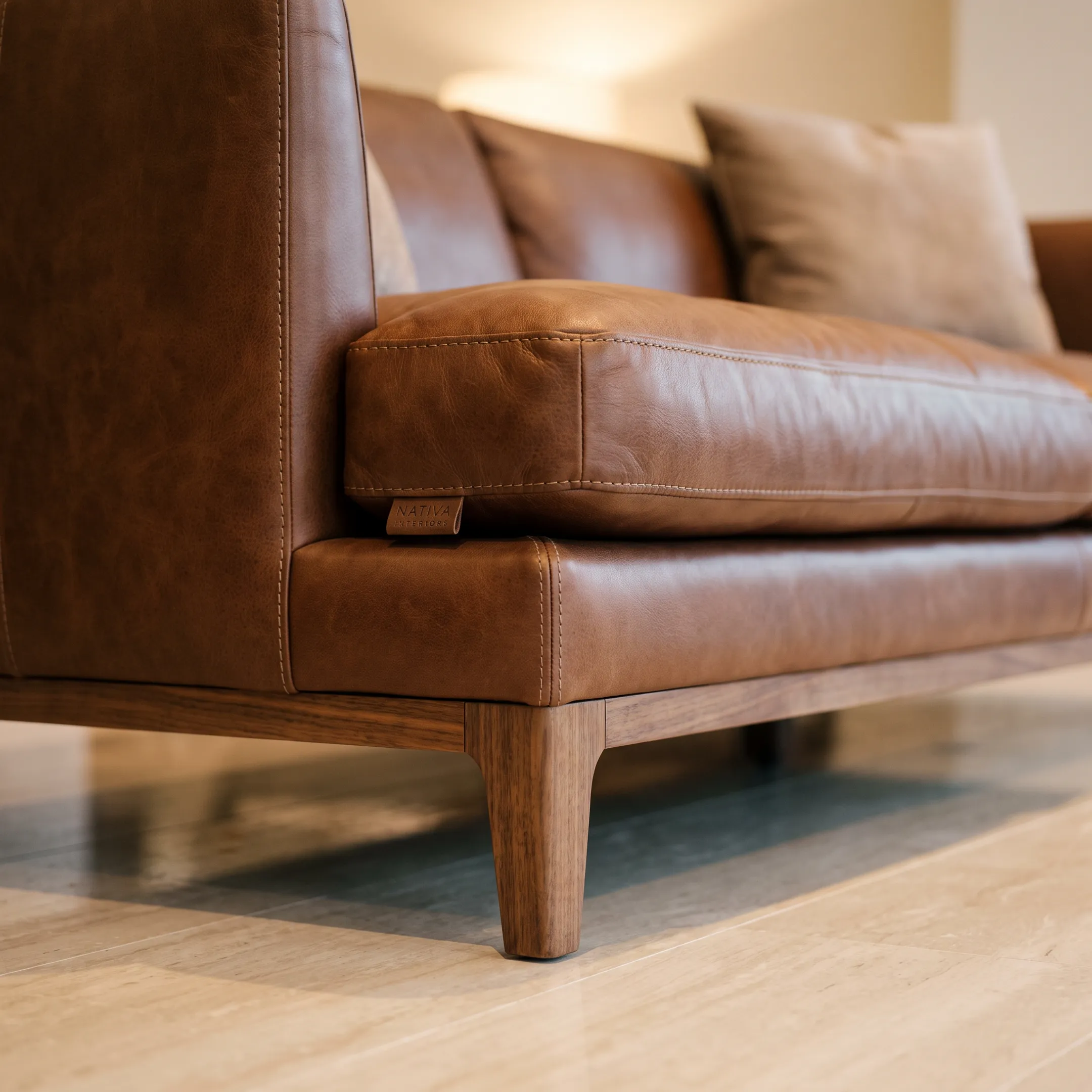 Handcrafted luxury leather sofa with tailored stitching in a design showroom.