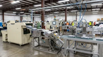 NEDCO automatic apparel labeling system integrated within complete production line