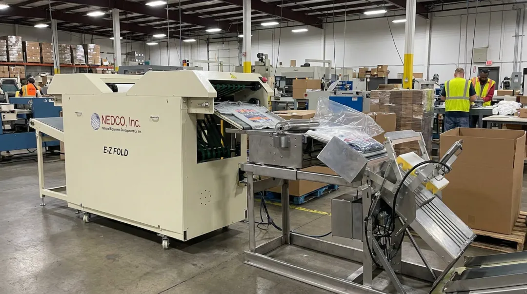 NEDCO E-Z Fold automatic t-shirt folding machine integrated packaging line