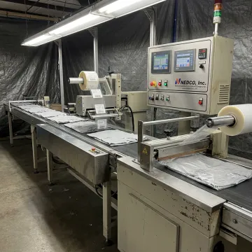 Custom label film equipment for apparel manufacturing