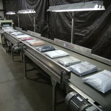 Package conveyor system in production facility