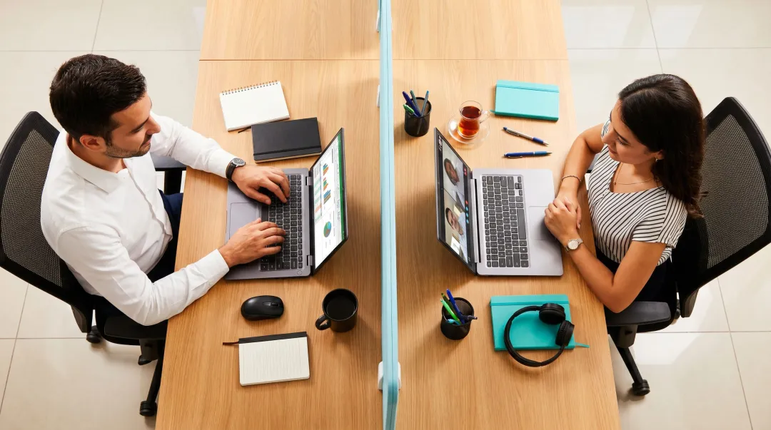 Two people working side by side in body doubling virtual accountability session