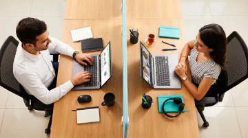 Two people working side by side in body doubling virtual accountability session