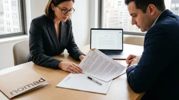 Commercial real estate attorney and tenant reviewing lease assignment documents at office table