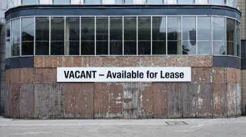Commercial office building vacancy sign showing empty space available for lease