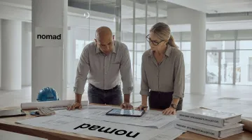 Nomad Group construction team reviewing office buildout plans and cost scope documents