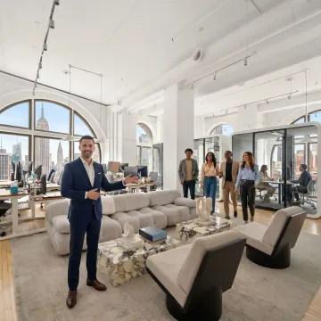 Startup team touring modern office space with broker