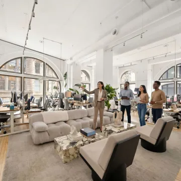 Startup team touring modern office space with broker